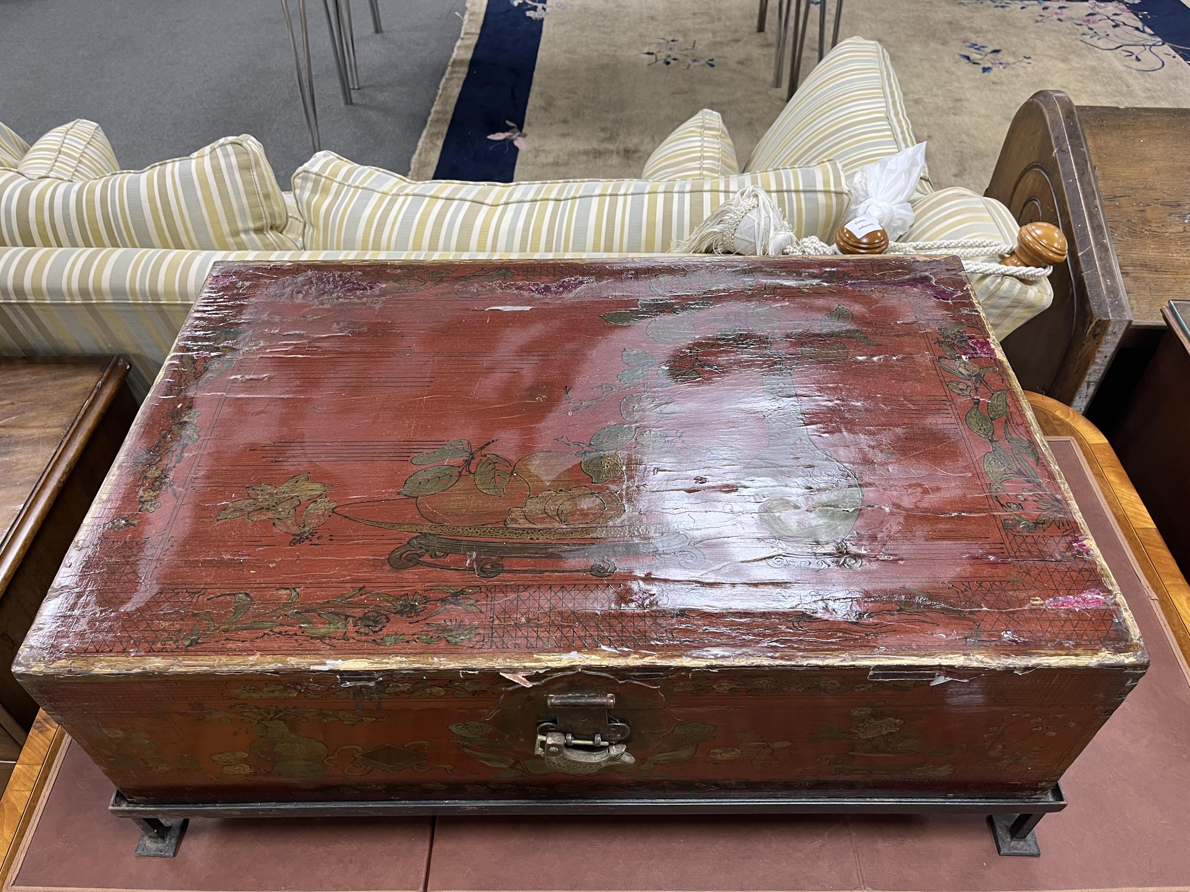 A Chinese lacquer trunk, on an associated metal stand, width 84cm, depth 53cm, height 31cm. Condition - poor